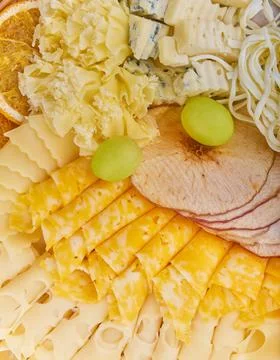 Top view different kinds of cheese with dried orange slices, dried apple slic Stock Photos