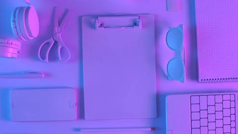 Top view of different stationery in vibrant gradient holographic neon color Video stock 201193289