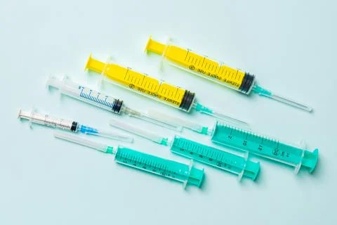 Top view of different syringes at blue background. Medical injection concep.. Фото