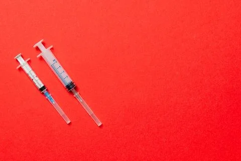 Top view of different syringes for injection on colorful background. Medical  Stock Photos