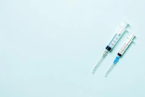 Top view of different syringes for injection on colorful background. Medica.. Stock Photos