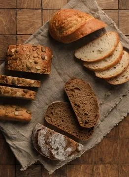 Top view of different Types of Bread with seeds and spices on the wood back.. Stock Photos