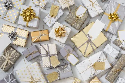 Top view different wrapped gift boxes on white marble multicolored various Stock Photos
