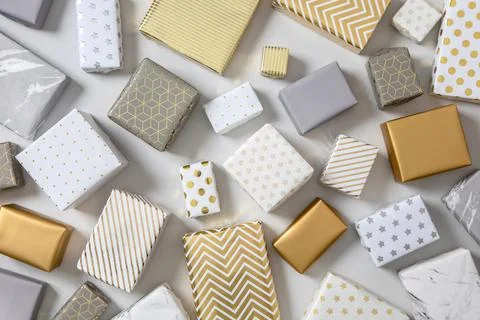 Top view different wrapped gift boxes on white marble multicolored various Stock Photos