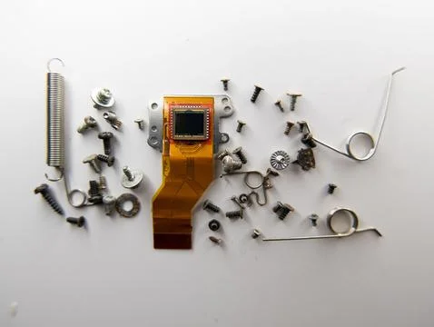 Top view of a digital camera sensor, screws, tension springs on a white backgrou Stock Photos