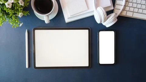 Top view digital tablet and mobile phone with blank screen on table. Stock-Fotos