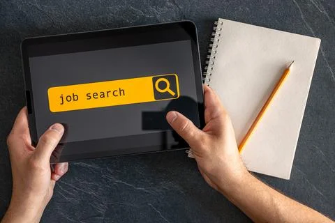 Top view of digital tablet with search job on screen in male hands. Stock Photos