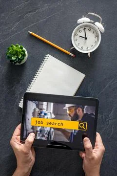 Top view of digital tablet with search job on screen in male hands. Stock Photos