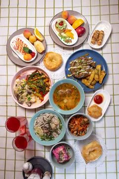 Top view of the dining table with delicious dishes served in a cafe or restau Stock Photos