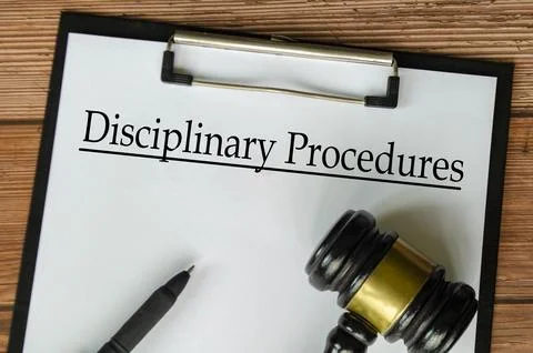 Top view of Disciplinary Procedures text on white paper clipboard with gave.. Stock Photos