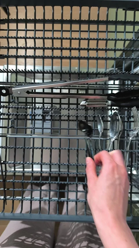 Top view of dishwasher cutlery tray during point of view unloading. Hand re.. Stock Footage 344892078