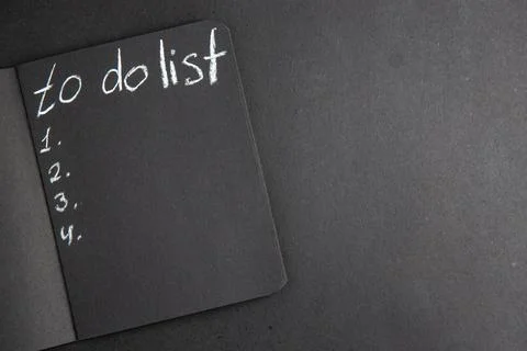 Top view to do list written on black notebook on black table free space Stock Photos