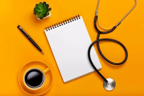 Top view of a doctor's table with notepad and pen stethoscope, keyboard, pres Stock Photos
