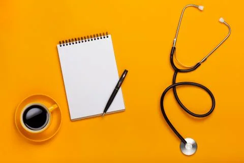 Top view of a doctor's table with notepad and pen stethoscope, keyboard, pres Stock Photos