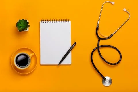 Top view of a doctor's table with notepad and pen stethoscope, keyboard, pres Stock Photos