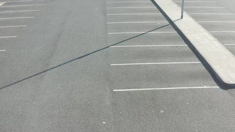 Top view of dog chasing a ball in a car park Video stock 130980983