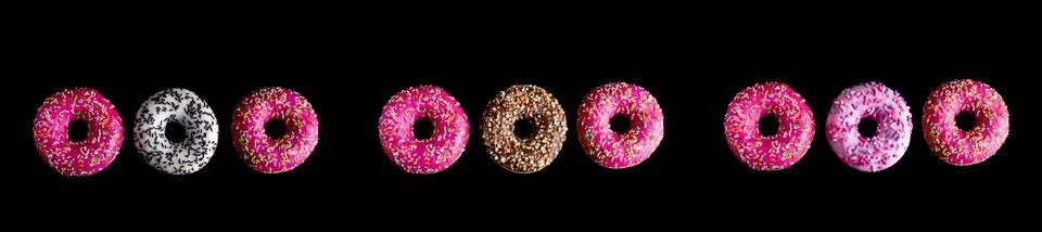 Top view donuts pattern on a black background banner Foto stock