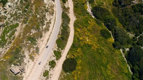 Top view down two ATVs riding mountain road, Cyprus Stock Footage 119339909