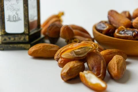 Top view of dried dates served on a wooden bowl and Arabic lantern Stock Photos