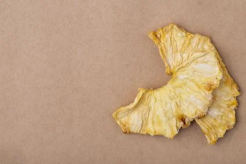 Top view of dried pineapple slices isolated on brown paper texture backgrou.. Stock Photos