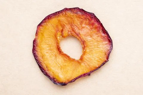 Top view of dried plum slice isolated on brown paper texture background Stock Photos