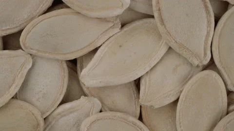 Top view of dried pumpkin seeds in a husks rotating. Closeup. Macro. Vídeo Stock 170642821