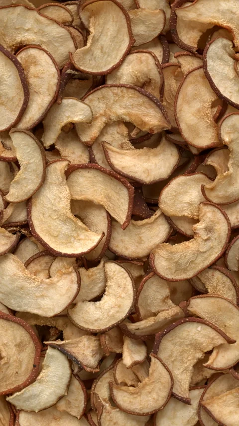 Top view of dried sliced Asian pears background texture. Vertical video. Stock Footage 303889294