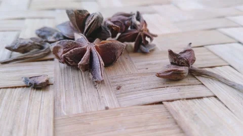 Top View of Dried Star Anise Spices Arranged on a Textured Wooden Surface Stock Footage 343520197