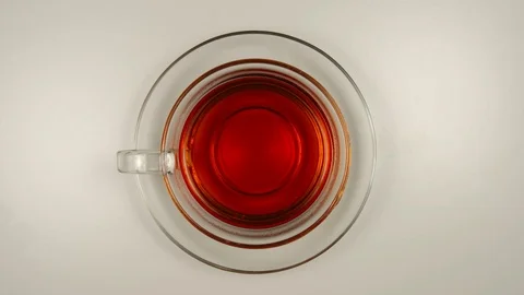 TOP VIEW: Drinking a black tea from a glass tea cup - Stop motion Vídeo Stock 93597723