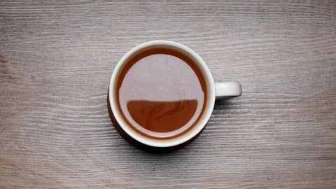 TOP VIEW: Drinking a cup of coffee with milk from a white coffee cup - Stop m Stock Footage 107224686