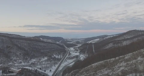 Top view. Drone Aerial Flight in the mountains in winter. Mountain road Stock Footage 94662291