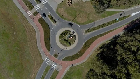 Top view drone aerial of roundabout with cycle lane and traffic, The Netherlands Stock Footage