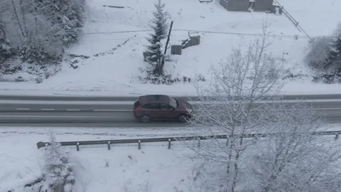 Top view from a drone of a car driving on a snowy Stockbeeldmateriaal 236774714