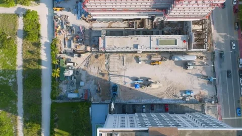 Top view from drone on construction of city skyscrapers in green area of busy Stock Footage 245955407