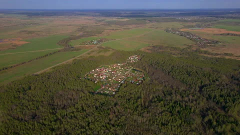 Top view from a drone on the cottage settlement surrounded by green forest and Stock Footage 236872943