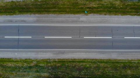 Top view drone flying above the road with driving cars and trucks. Horisontal Stock Footage 114124500