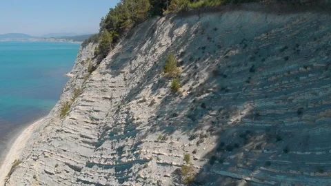 Top view from Drone flying over the white rocks with a blue see Stock Footage 126828302