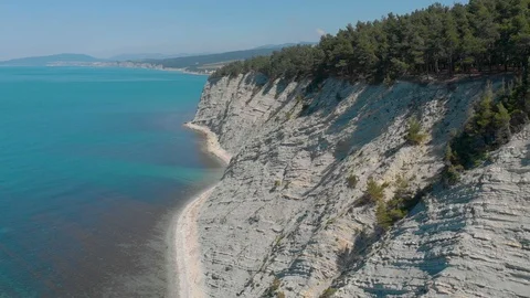 Top view from Drone flying over the high white rocks with a deep blue see Stock Footage 126828649