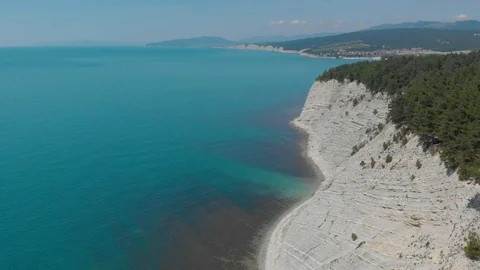Top view from Drone flying over the white rocks with blue see Stock Footage 126828879