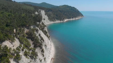 Top view from Drone flying over the high white rocks with a deep blue see Stock Footage 126829240