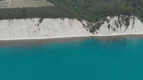 Top view from Drone flying over the white rocks with a deep blue see Stock Footage 126829302