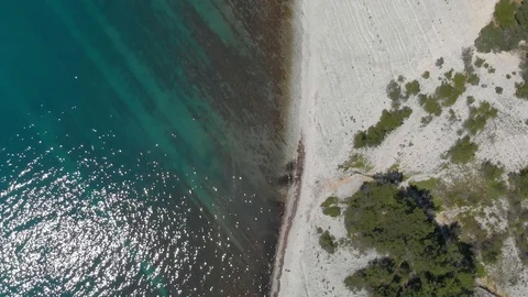 Top view from Drone flying over the high white rocks with a blue see Stock Footage 126829372