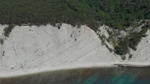 Top view from Drone flying over the white rocks surrounded by deep blue see Stock Footage 126829453