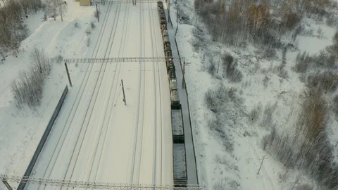 Top view from a drone on a freight train, a long train, approaching the station Video stock 126360036