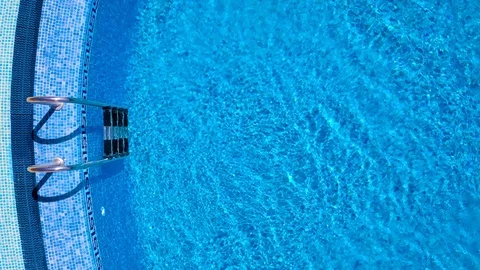 Top view from a drone over the ladder and surface of the pool Stock Footage 112519684