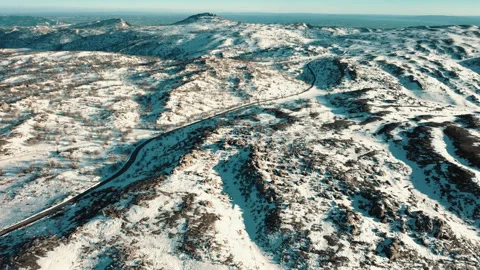 Top view drone of a road separating snowy mountains Stock Footage 236968491