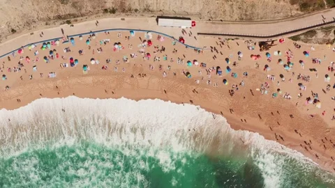 Top view from a drone of a sandy beach by the ocean with vacationing tourists. Stock Footage 304101419