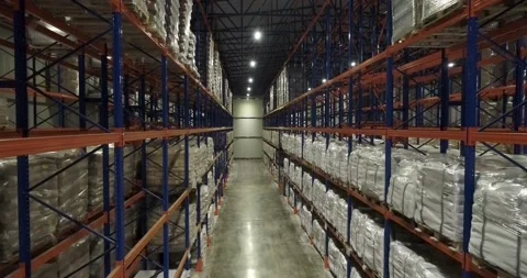 Top view, drone shot of rows of pallets in warehouse. A path through racks of Video stock 135056638