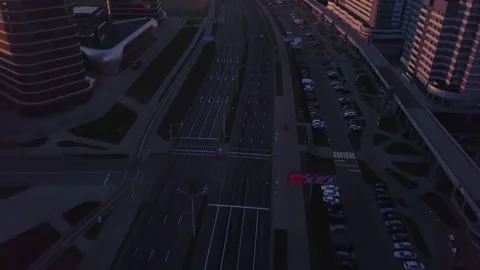 Top view drone tilts up on flying above city street on early sunrise in Minsk Stock Footage 135056056