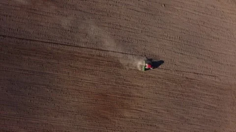 Top view from a drone of a tractor plowing and sowing ground Stock Footage 241016900